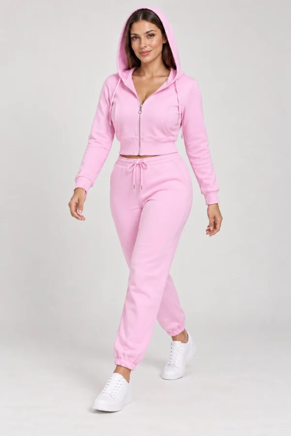 Pink zip-up hoodie and jogger set, walking hood-up view